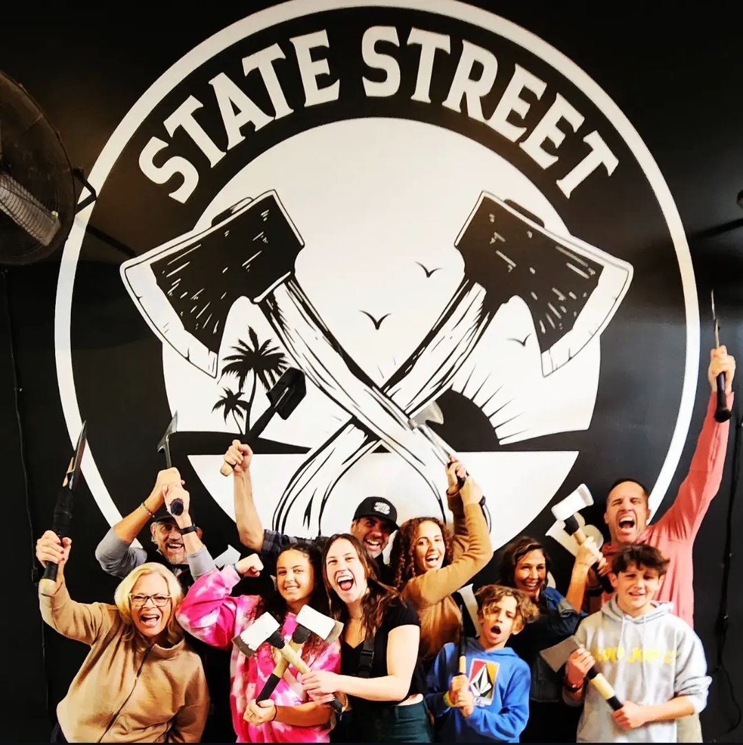 Group cheering with axes at State Street Axe Club