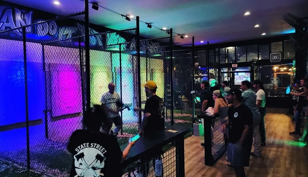 Neon-lit axe throwing lanes at State Street Axe Club