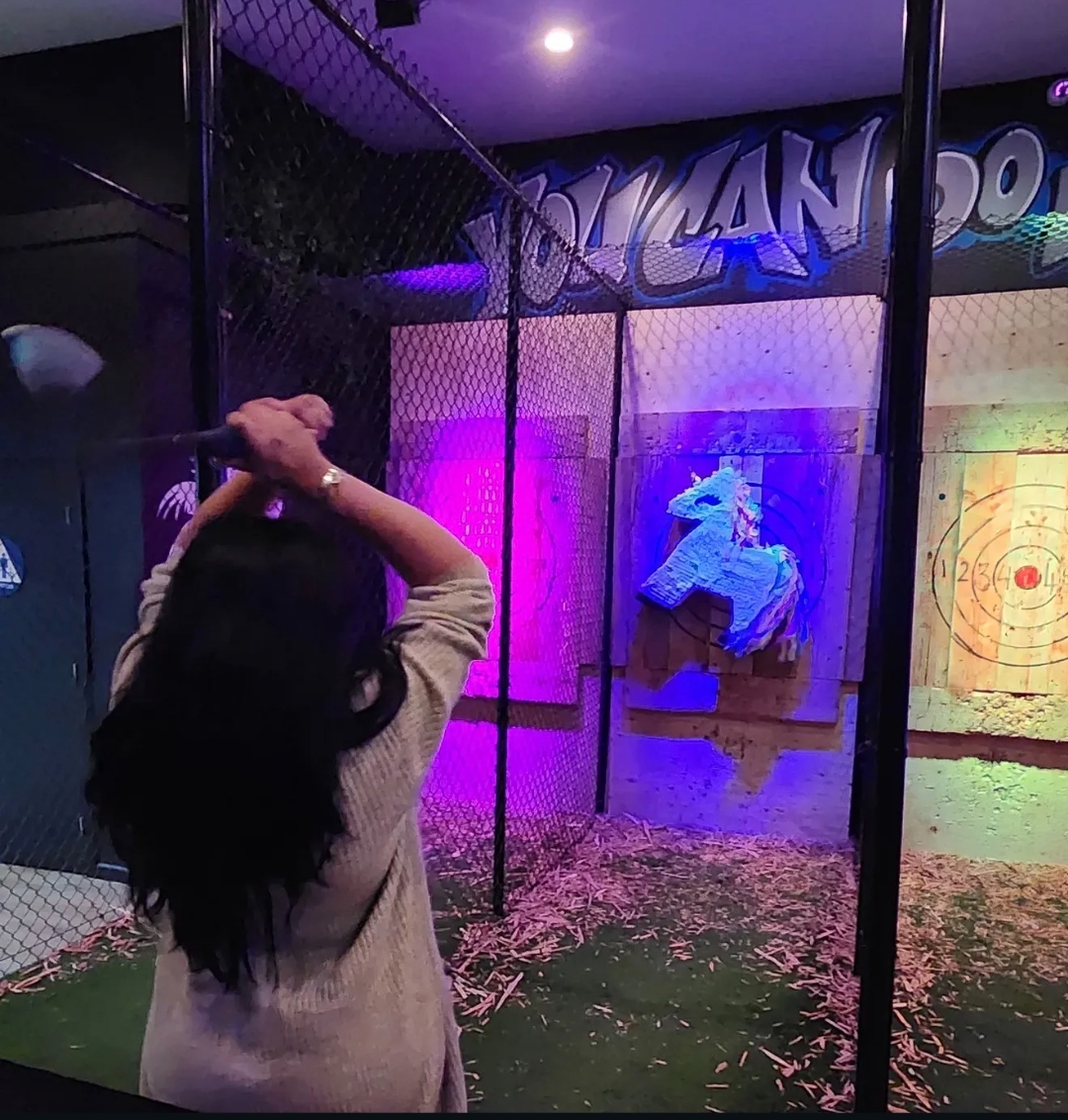 Woman throwing an axe at State Street Axe Club